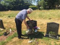 Tony tending Alli's grave